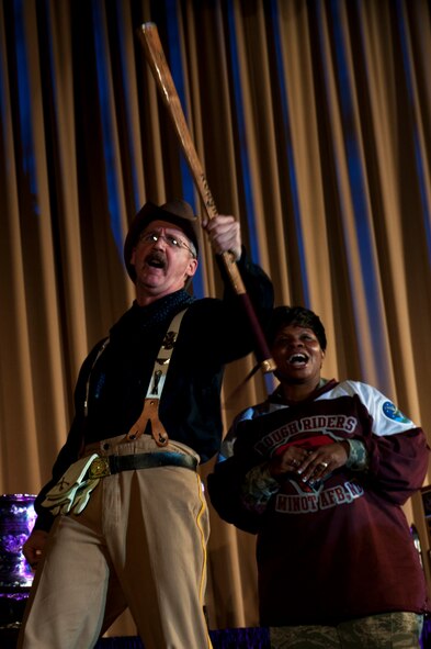 Chief Master Sgt. Felica Noil, 91st Missile Wing command chief and retired Master Sgt. David Larrison, 91st MW mascot Teddy, chant during the Global Strike Challenge trophy take-back event on Barksdale Air Force Base, La., Nov. 3, 2014. GSC is the world's premier bomber, Intercontinental Ballistic Missile, helicopter operations and security forces competition with units from Air Force Global Strike Command, Air Combat Command, Air Force Reserve Command and the Air National Guard. (U.S. Air force photo/Senior Airman Brittany Y. Bateman)
