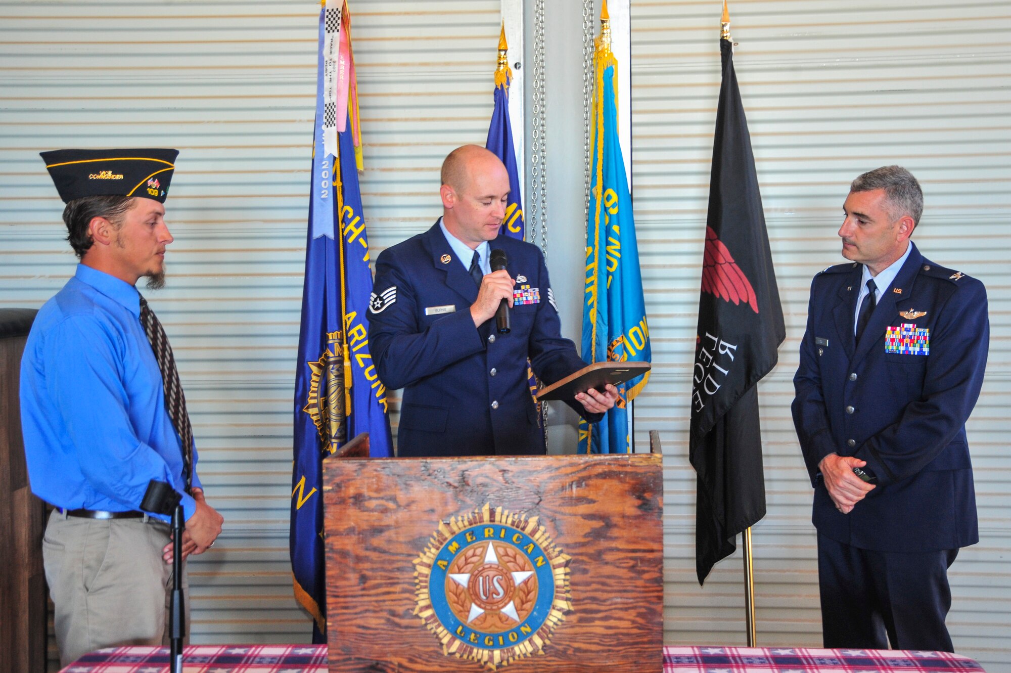 American Legion Post 109 vice commanders, Seth Jones, and U.S. Air Force Staff Sgt. Shaun Burns, 355th Maintenance Group,  present a plaque of appreciation to Col. Stephen L. Renner, 355th Fighter Wing vice commander, during a Veteran’s Day ceremony at the American Legion Post 109, Vail, Ariz., Nov. 8, 2014.  Renner, who served as the guest speaker for the ceremony, emphasized the weight of the word “sacrifice” and what it has means to our nation’s veterans.  (U.S. Air Force Photo by Airman 1st Class Chris Massey/Released)