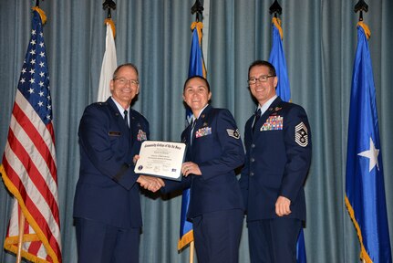 U.S. Air Force members at Joint Base San Antonio receive their Community College of the Air Force degrees Nov. 7, at a ceremony in the Fleenor Auditorium at Joint Base San Antonio-Randolph.  CCAF is federally-chartered degree-granting institution that serves the United States Air Force’s enlisted total force.  (U.S. Air Force photo/Desiree Palacios)