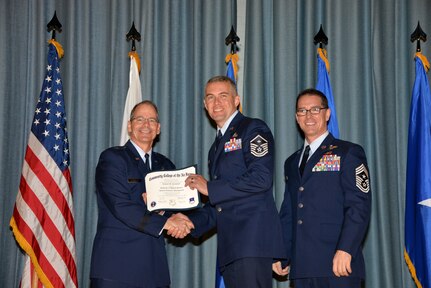U.S. Air Force members at Joint Base San Antonio receive their Community College of the Air Force degrees Nov. 7, at a ceremony in the Fleenor Auditorium at Joint Base San Antonio-Randolph.  CCAF is federally-chartered degree-granting institution that serves the United States Air Force’s enlisted total force.  (U.S. Air Force photo/Desiree Palacios)