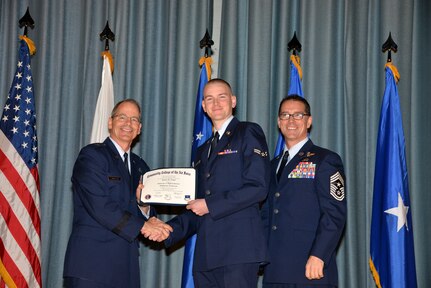 U.S. Air Force members at Joint Base San Antonio receive their Community College of the Air Force degrees Nov. 7, at a ceremony in the Fleenor Auditorium at Joint Base San Antonio-Randolph.  CCAF is federally-chartered degree-granting institution that serves the United States Air Force’s enlisted total force.  (U.S. Air Force photo/Desiree Palacios)