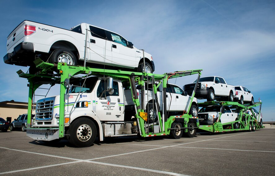 Ford F-150s are unloaded on Minot Air Force Base, N.D., Oct. 31, 2014. The trucks were purchased to be utilized by 91st Missile Wing Airmen who travel out to missile sites for crew changeover. At approximately seven years old, the older vehicles have experienced wear and tear from the unique mission and weather Minot has. (U.S. Air Force photo/Airman 1st Class Sahara L. Fales)