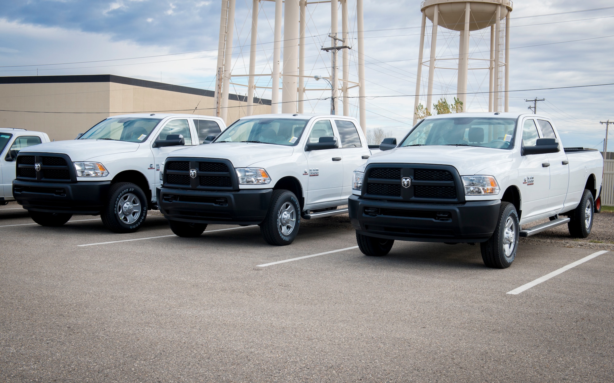 Brand new Dodge Ram 3500s sit in a parking lot on Minot Air Force Base, N.D., Oct. 29, 2014. The trucks were bought as a part of the Force Improvement Program’s initiative to provide more positive, rapid and substantial changes within the ICBM and bomber missions. Because the old vehicles weren’t designed to be on Minot’s dirt roads consistently, driving along the roads full of gear and Airmen has worn down the suspension and transmissions over time. (U.S. Air Force photo/Airman 1st Class Sahara L. Fales)