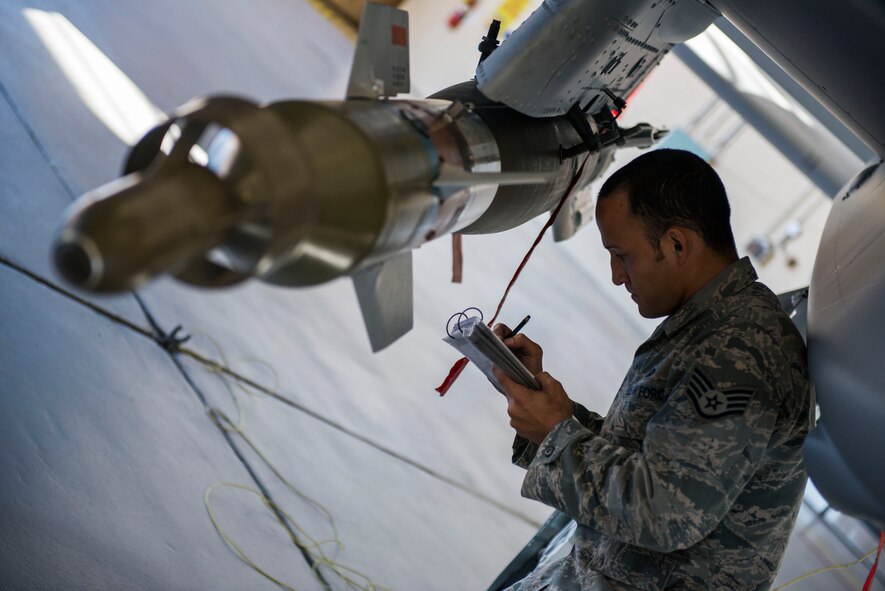 U.S. Air Force Staff Sgt. Brian Crews, 75th Aircraft Maintenance Unit load crew chief, reviews a checklist during a quarterly weapons load competition Nov. 7, 2014, at Moody Air Force Base, Ga. Crews performed a last-minute check to ensure proper connections between the missile and the A-10C Thunderbolt II. (U.S. Air Force photo by Airman 1st Class Dillian Bamman/Released)