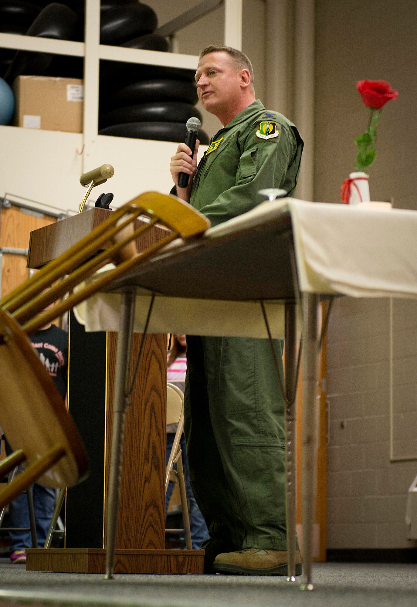 Col. Kieran Denehan, 5th Operations Group commander, reads a story to North Plains Elementary School students on Minot Air Force Base, N.D., Nov. 7, 2014. Denehan read “America’s White Table” to the students during their Veteran’s Day program to inform them about the table that is set in remembrance of prisoners of war and those missing in action. (U.S. Air Force photo/Airman 1st Class Sahara L. Fales)