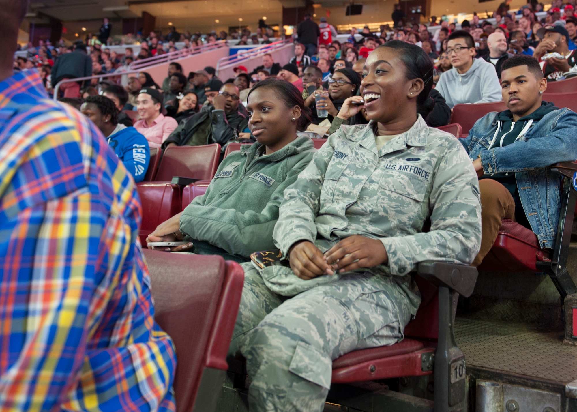 Airman 1st Class Jalisa Goldsboro, 436th Comptroller Squadron financial services technician, and Airman 1st Class Alberta Anthony, 436th CPTS command support administrator, watch a Chicago Bulls versus Philadelphia 76ers basketball game Nov. 7, 2014, at the Wells Fargo Center, in Philadelphia. Goldsboro and Anthony were two of several Team Dover Airmen to attend the game. (U.S. Air Force photo/Airman 1st Class Zachary Cacicia)