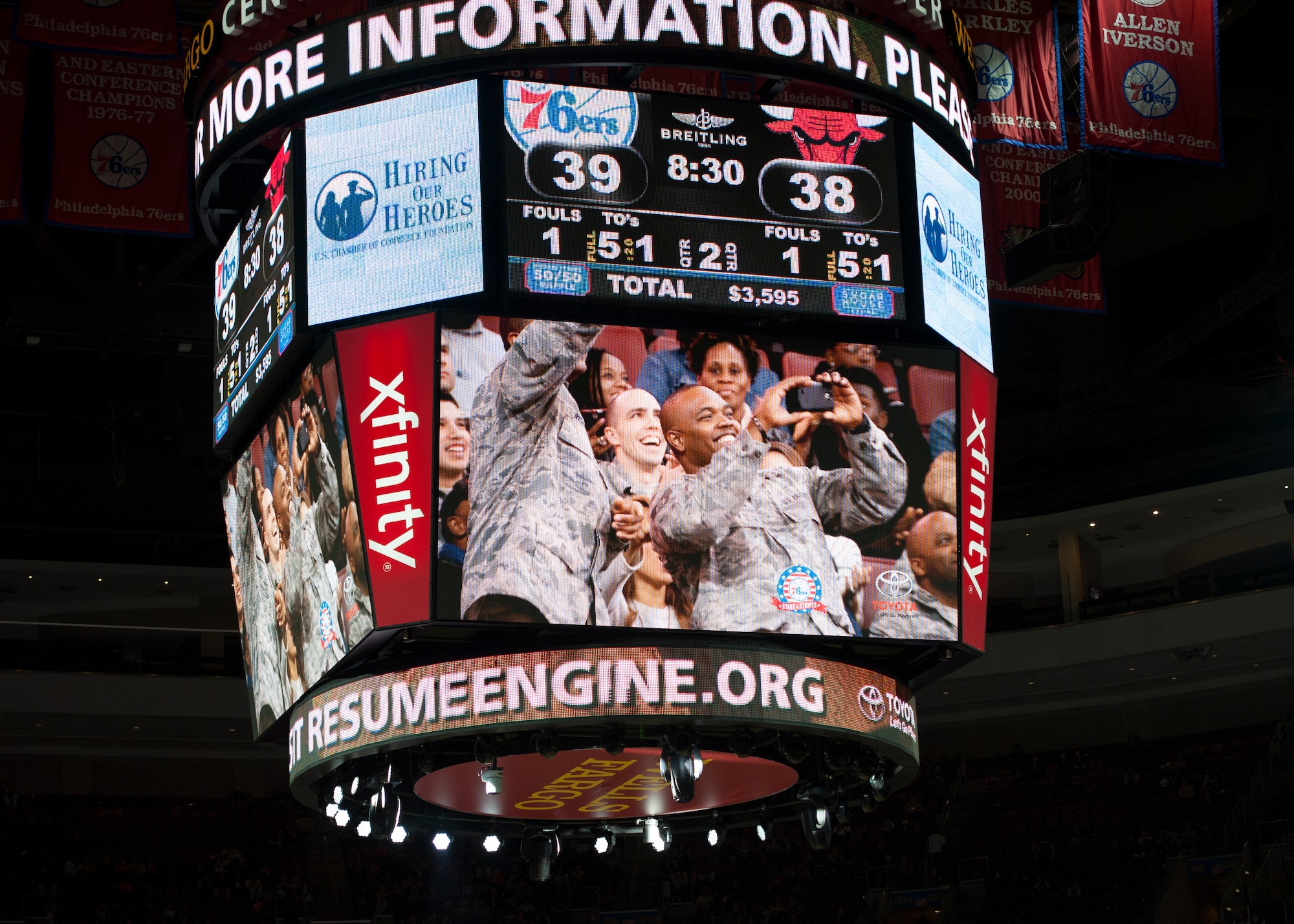 Several Team Dover Airmen react to being shown on the arena Jumbotron during a Chicago Bulls versus Philadelphia 76ers basketball game Nov. 7, 2014, at the Wells Fargo Center, in Philadelphia. Many service members were featured on the Jumbotron throughout the game. (U.S. Air Force photo/Airman 1st Class Zachary Cacicia)
