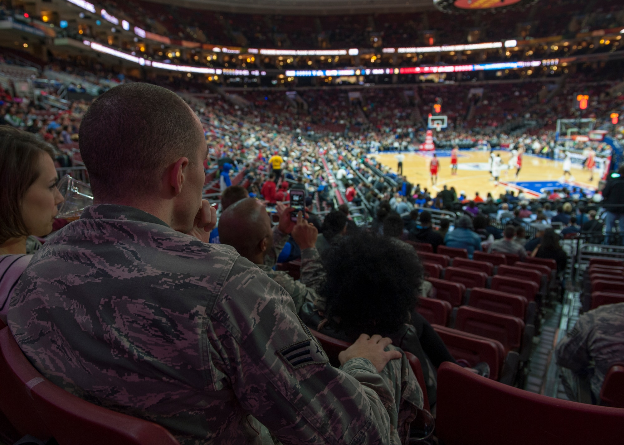 Senior Airman Brady O’Neill, 436th Comptroller Squadron financial analyst, watches a Chicago Bulls Philadelphia 76ers basketball game Nov. 7, 2014, at the Wells Fargo Center, in Philadelphia. Tickets were provided to service members in support of the NBA’s “Commitment to Service” program, a collaboration between the NBA, USA Basketball and the Department of Defense. (U.S. Air Force photo/Airman 1st Class Zachary Cacicia))