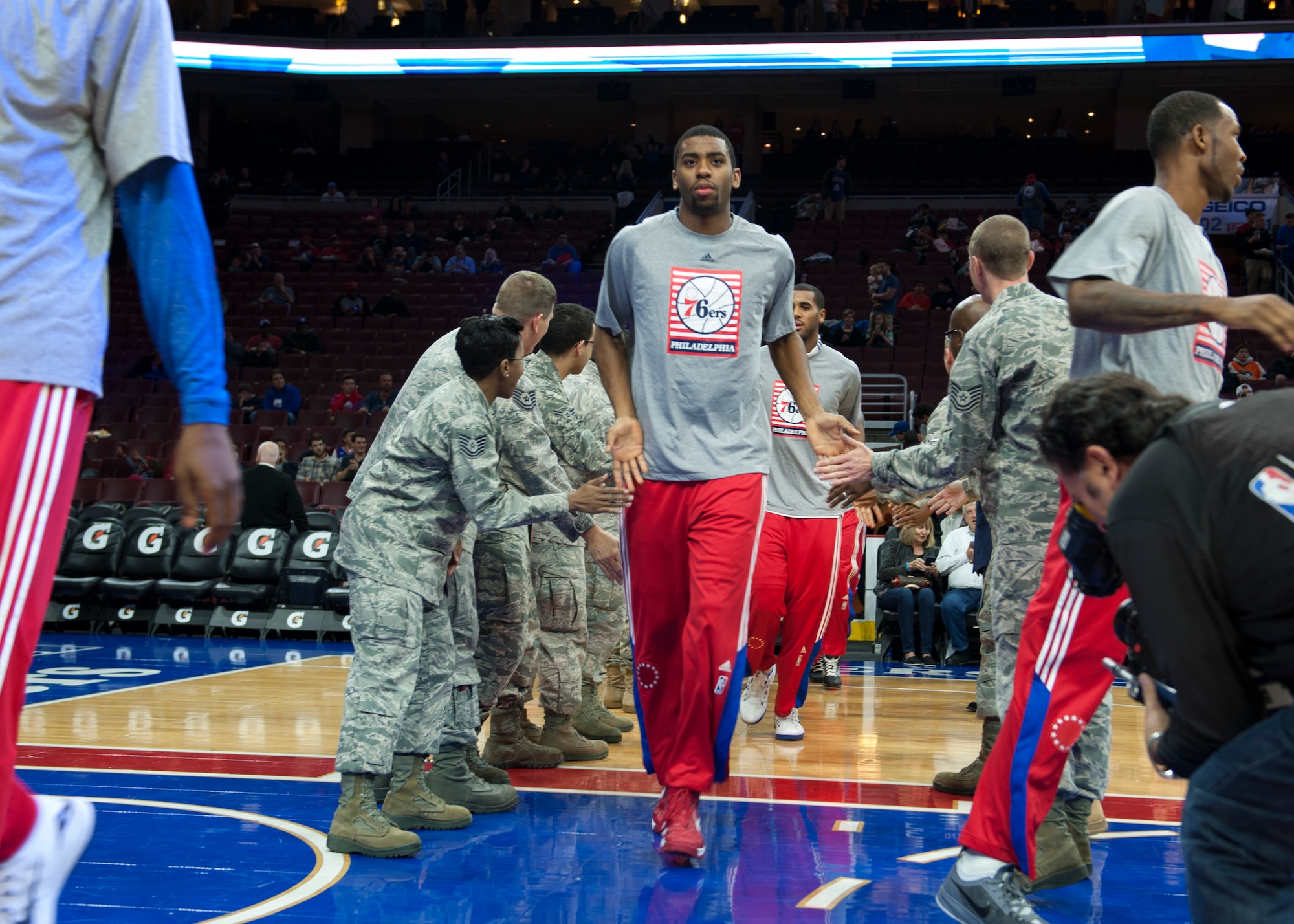 Hollis Thompson, 76ers guard/forward, and the rest of the 76ers team high-five U.S. military service members prior to a Chicago Bulls versus Philadelphia 76ers basketball game Nov. 7, 2014, at the Wells Fargo Center, in Philadelphia. The 76ers organization hosted hundreds U.S. military servicemen for a special “Commitment to Service” night. (U.S. Air Force photo/Airman 1st Class Zachary Cacicia)