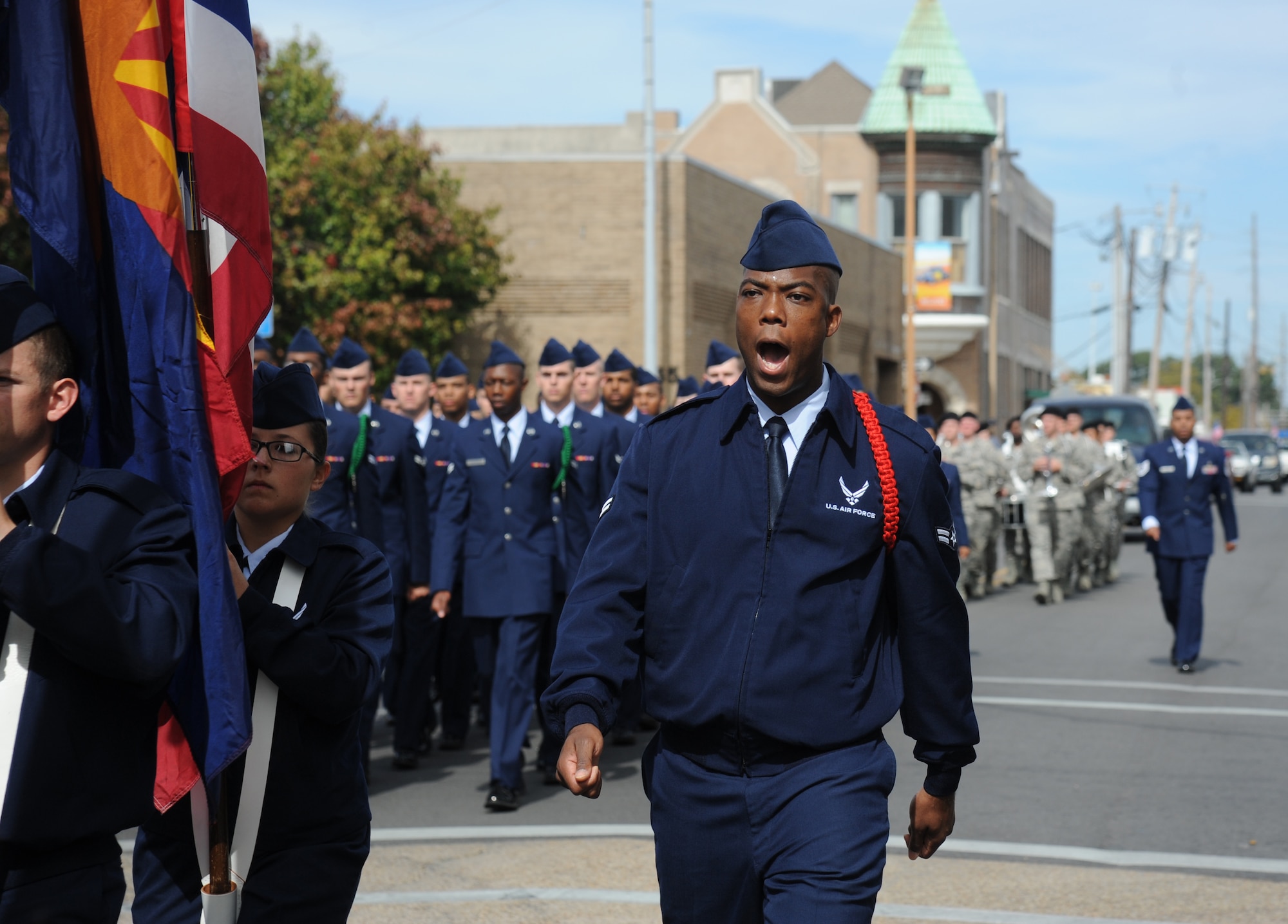 Airmen 1st Class Michael Barnes, 338th Training Squadron student, calls cadence for Airmen carrying the 50 State Flags during the 14th Annual Gulf Coast Veterans Day Parade in front of City Hall Nov. 8, 2014, Biloxi, Miss.  Keesler’s Wing leadership, Honor Guard and 81st Training Group’s Drum and Bugle Corps also participated in the event. (U.S. Air Force photo by Kemberly Groue)