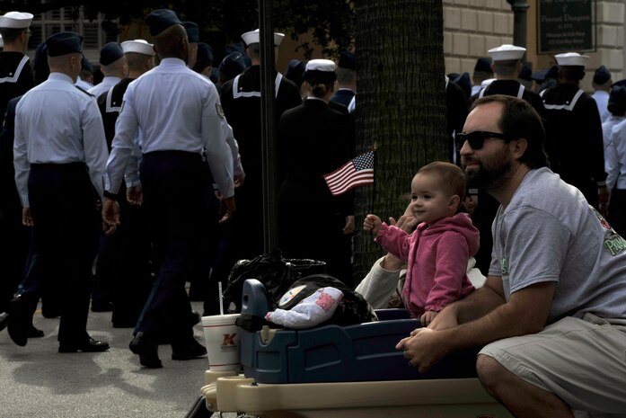 Thousands of LowCountry residents line the streets to watch the Veterans Day Parade Nov. 8, 2014, in Charleston, S.C. The parade was 1.2 miles long and included a C-17 flyover, a formation of Joint Base Charleston service members, and 45 other military oriented groups from the local area. (U.S. Air Force photo/Staff Sgt. Renae Pittman)