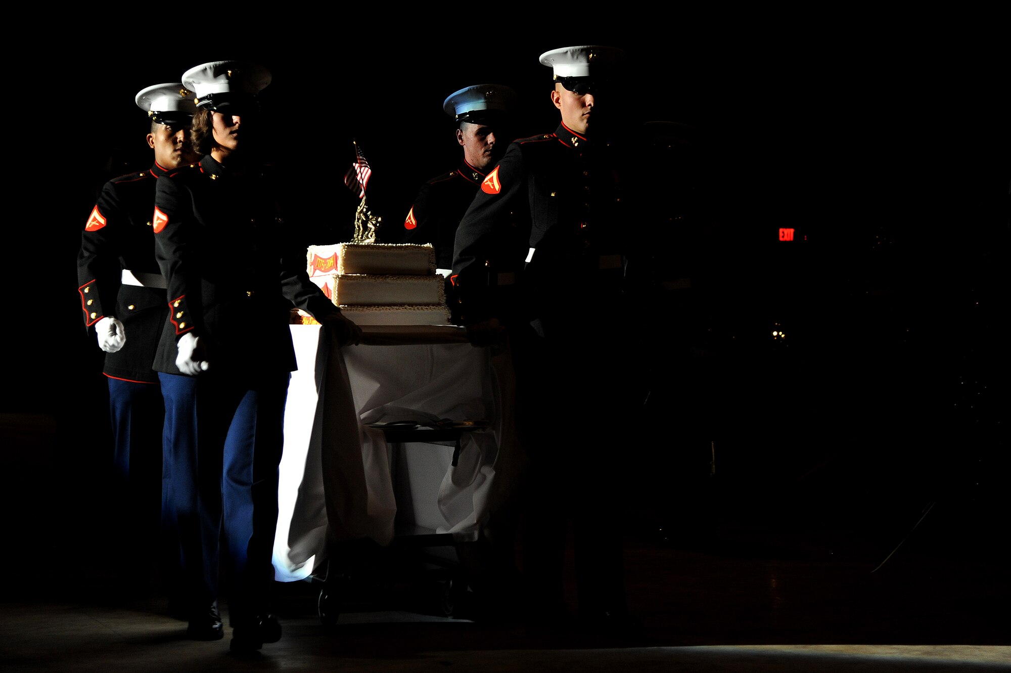 SAN ANGELO, Texas – Marines carry the U.S. Marine Corps birthday cake during the Marine Corps Ball at the McNease Convention Center Nov. 8. It is customary at Marine Corps birthday celebrations for the first piece of cake to be given to the guest of honor and the second to be given to the oldest Marine who will in turn pass it on to the youngest Marine. (U.S. Air Force photo/ Airman 1st Class Devin Boyer)