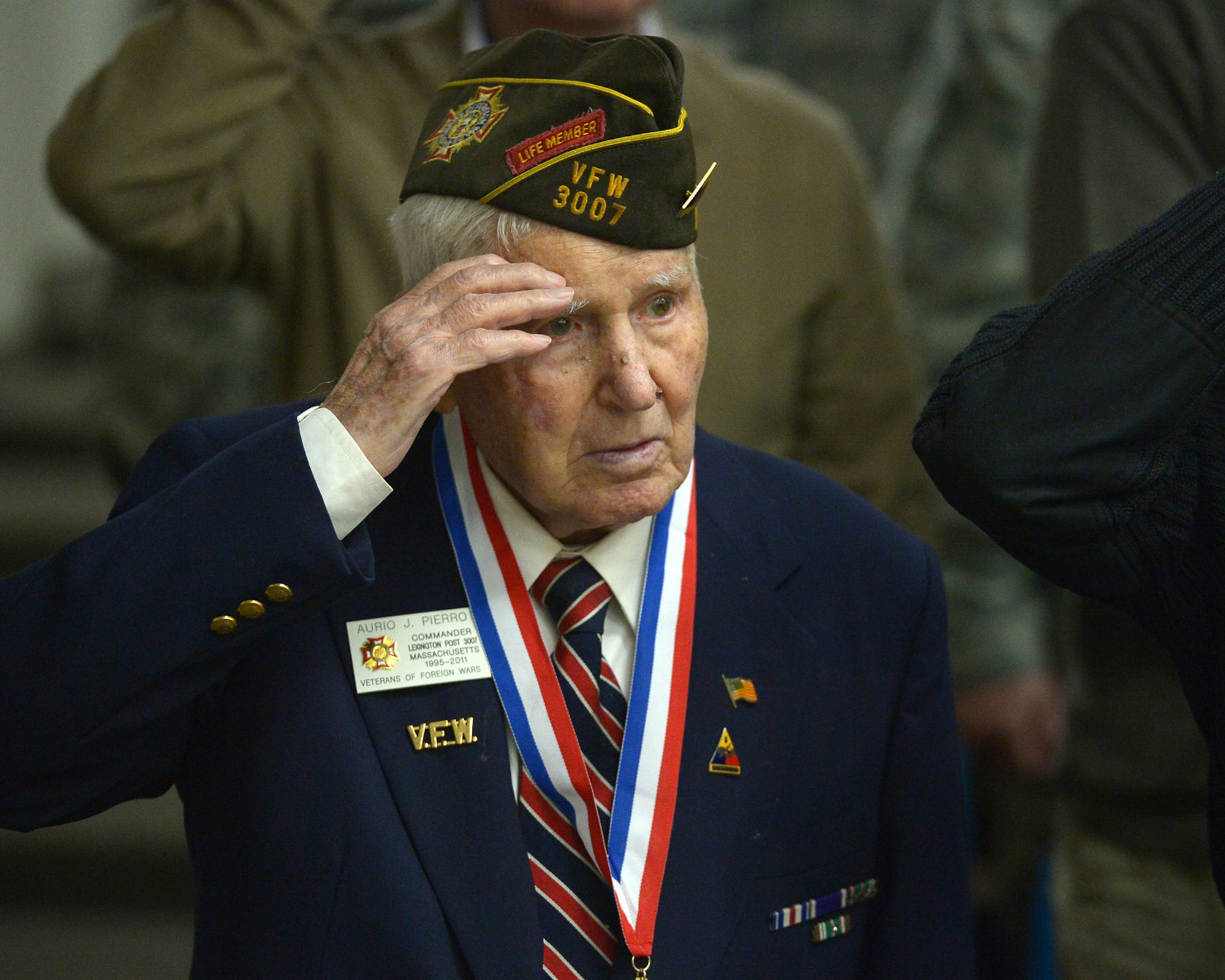World War II veteran Aurio Pierro salutes the American flag during the Hanscom Salute to Veterans ceremony at the Hanscom Conference Center Nov. 7. Pierro served in the U.S. Army’s 3rd Armored Division during the Second World War and achieved the rank of staff sergeant. The base held the ceremony to recognize and thank local veterans for their service to the nation. Veterans from World War II to the current campaigns in Iraq and Afghanistan attended the event. (U.S. Air Force photos by Jerry Saslav)