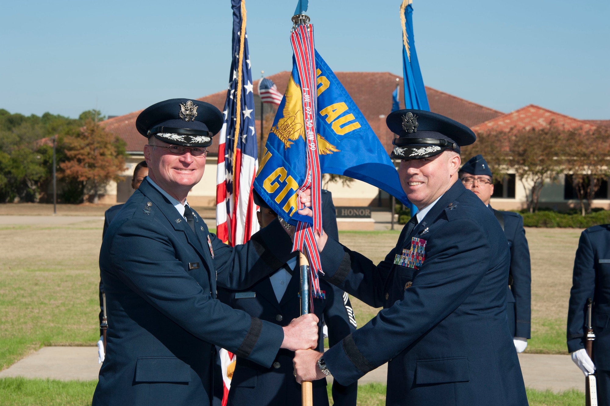 Brig. Gen. Paul Guemmer assumes command of the Jeanne M. Holm Center for Officer Accessions and Citizen Development during a change of command ceremony on Nov. 7, 2014, at Maxwell Air Force Base, Alabama. Presiding official for the change of command was Air University Commander and President, Lt. Gen. David Fadok, who retired Nov. 10. Relinquishing command was Brig. Gen. Robert Thomas. (U.S. Air Force photo by Bud Hancock)