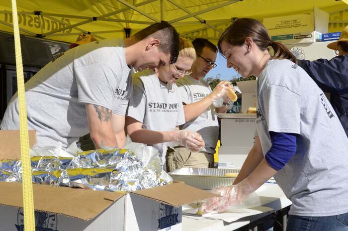 Sailors stationed at Naval Nuclear Power Training Command prepare food at the 15th Annual Stand Down for Homelessness Oct. 31, 2014, at the Danny Jones Recreation Complex in North Charleston S.C. The event offered medical and dental screenings and assistance, clothing, food and haircuts, as well as job assistance and legal counseling for hundreds of homeless persons in the greater Charleston area. (U.S. Navy photo/Petty Officer 2nd Class Jason Pastrick