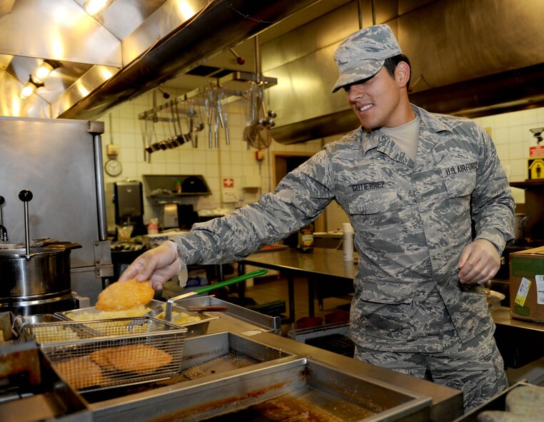 Airman Jerry Gutierrez, 22nd Force Support Squadron food service journeyman, places a chicken breast into a fryer, Nov. 10, at McConnell Air Force Base, Kan. The food was cooked and served to help feed approximately 250 Airmen during lunch hours. (U.S. Air Force photo/Airman 1st Class Tara Fadenrecht)