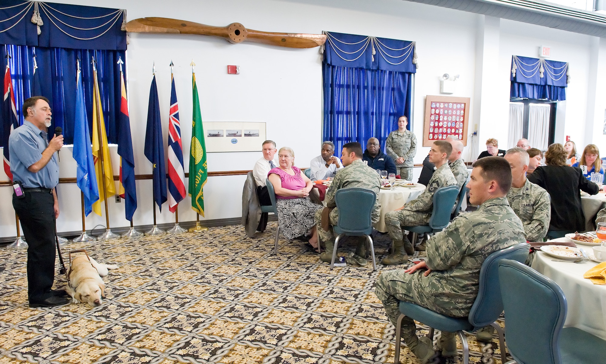 Lloyd Schmitz, National Disability Employment Awareness Month Luncheon guest speaker, left, speaks to Team Dover members Oct. 28, 2014, at The Landings on Dover Air Force Base, Del. Schmitz who is visually impaired, is a strong advocate for competitive gainful employment of individuals with disabilities. (U.S. Air Force photo/Roland Balik)