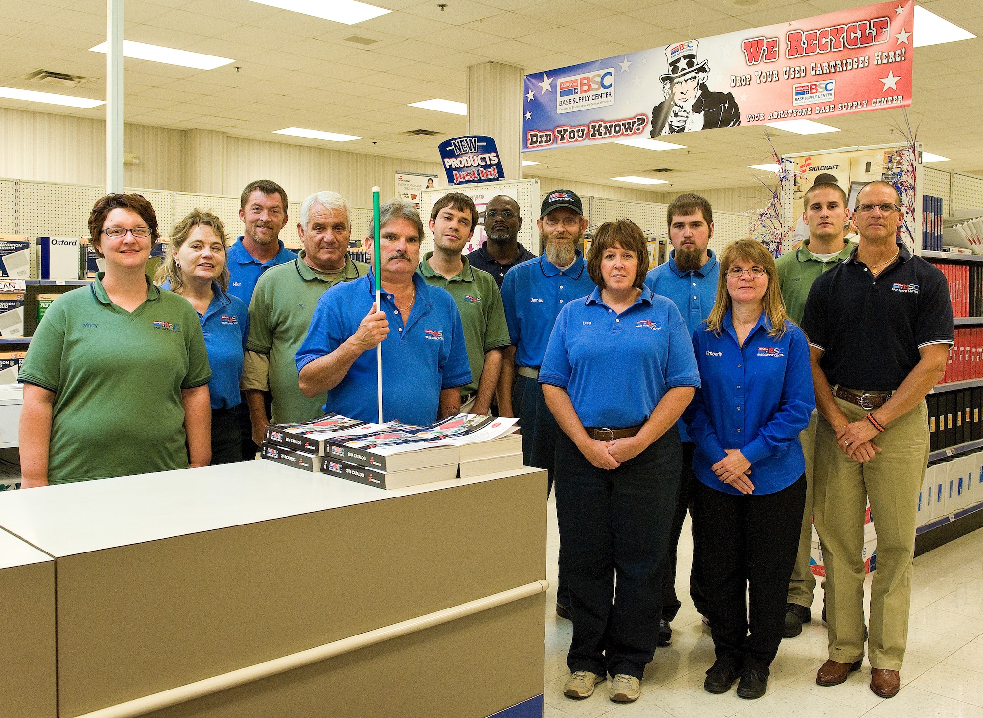 Employees of the AbilityOne Base Supply Center, a division of Blind Industries and Services of Maryland, pose for a photo Oct. 6, 2014, at the Base Supply Center on Dover Air Force Base, Del. Kim Utley, BSC store manager, third from right, is responsible for the BSC, Individual Equipment, Hazardous Material operations and employees. (U.S. Air Force photo/Roland Balik)