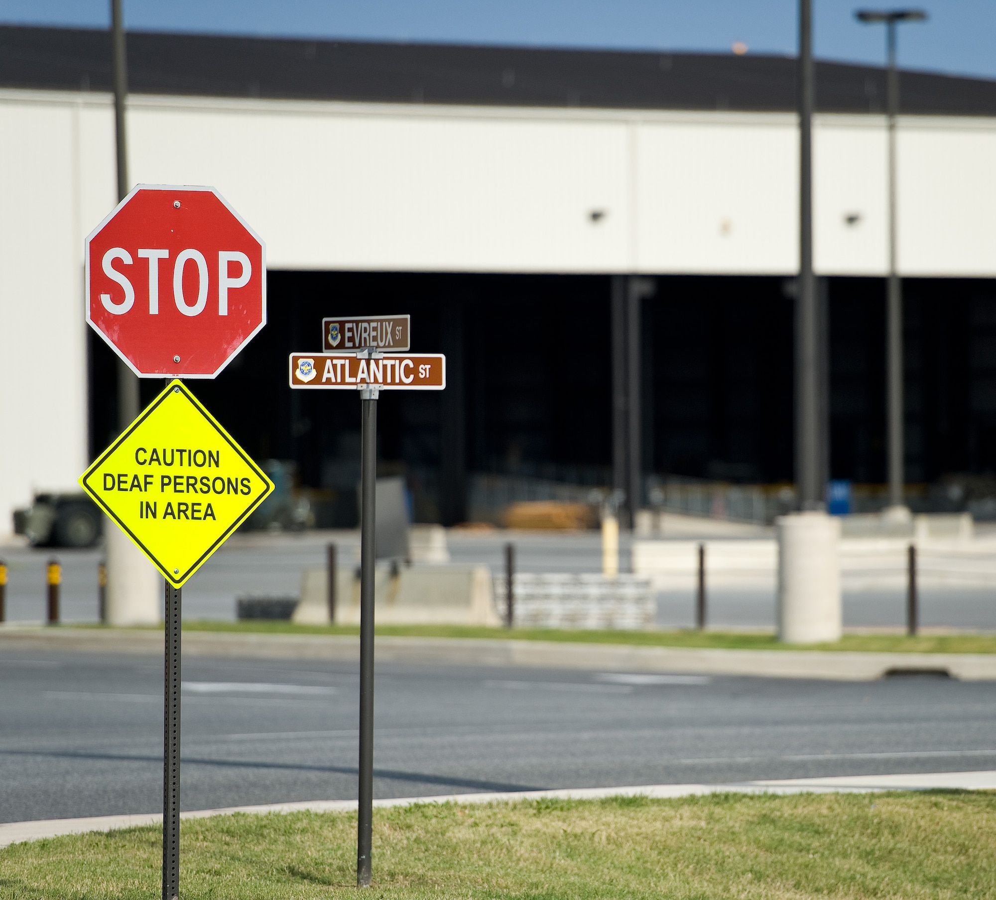 A sign at the corner of Evreux and Atlantic Streets informs drivers to be extra cautious of hearing impaired pedestrians crossing the streets Oct. 3, 2014, on Dover Air Force Base, Del. Three signs were placed near the Army and Air Force Exchange Service Express gas station/shoppette for driver awareness and pedestrian safety. (U.S. Air Force photo/Roland Balik)