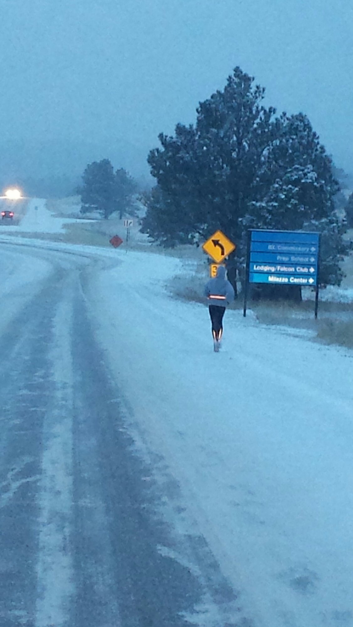 An Academy jogger runs on an icy road during snowfall at the Academy. Academy officials caution runners to watch out for snow removal crews while jogging during snowfall or bad weather. (U.S. Air Force photo)