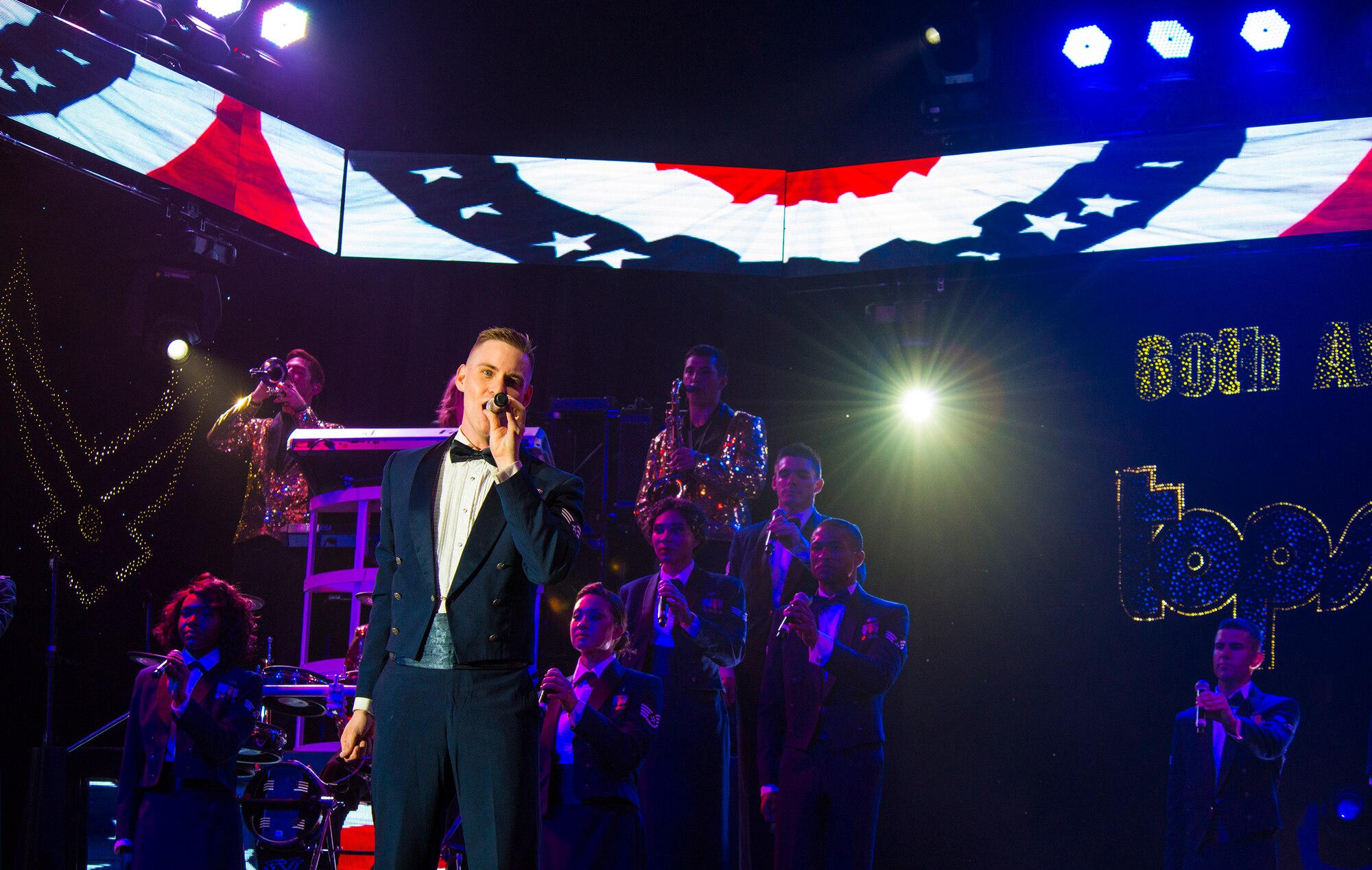 U.S. Air Force Senior Airman Kyle McCarthy, Tops in Blue vocalist, sings the final musical selection during a performance Nov. 6, 2014, at the Mathis Auditorium in Valdosta, Ga. As a part of Tops in Blue’s 60-year tradition, the show finale included the audience standing to sing the Air Force song. (U.S. Air Force photo by Airman 1st Class Ceaira Tinsley)