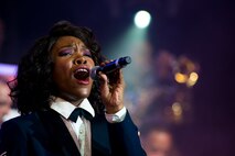 U.S. Air Force Senior Airman Nia Newton, Tops In Blue vocalist, sings during a performance Nov. 6, 2014, at the Mathis City Auditorium in Valdosta, Ga. The show historically ends with the singing of the Air Force Song. (U.S. Air Force photo by Airman 1st Class Ryan Callaghan/Released)