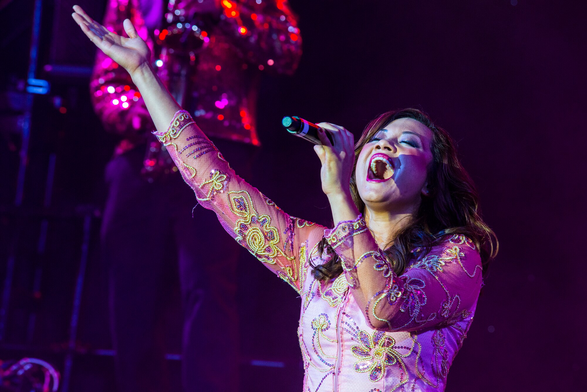 U.S. Air Force Senior Airman Mayra Hernandez, Tops in Blue vocalist, sings during a performance Nov. 6, 2014, at the Mathis Auditorium in Valdosta, Ga. Hernandez is a nutritional medicine journeyman with the 336th Medical Support Squadron at Mountain Home Air Force Base, Idaho. (U.S. Air Force photo by Airman 1st Class Ceaira Tinsley)