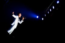 U.S. Air Force Senior Airman Jeremiah Barnes, Tops In Blue vocalist, sings during a performance Nov. 6, 2014, at the Mathis City Auditorium in Valdosta, Ga. Tops In Blue uses the equivalent of 556 lights, more than two miles of cable and more the 60,000 pounds of equipment for each show. (U.S. Air Force photo by Airman 1st Class Ryan Callaghan/Released)