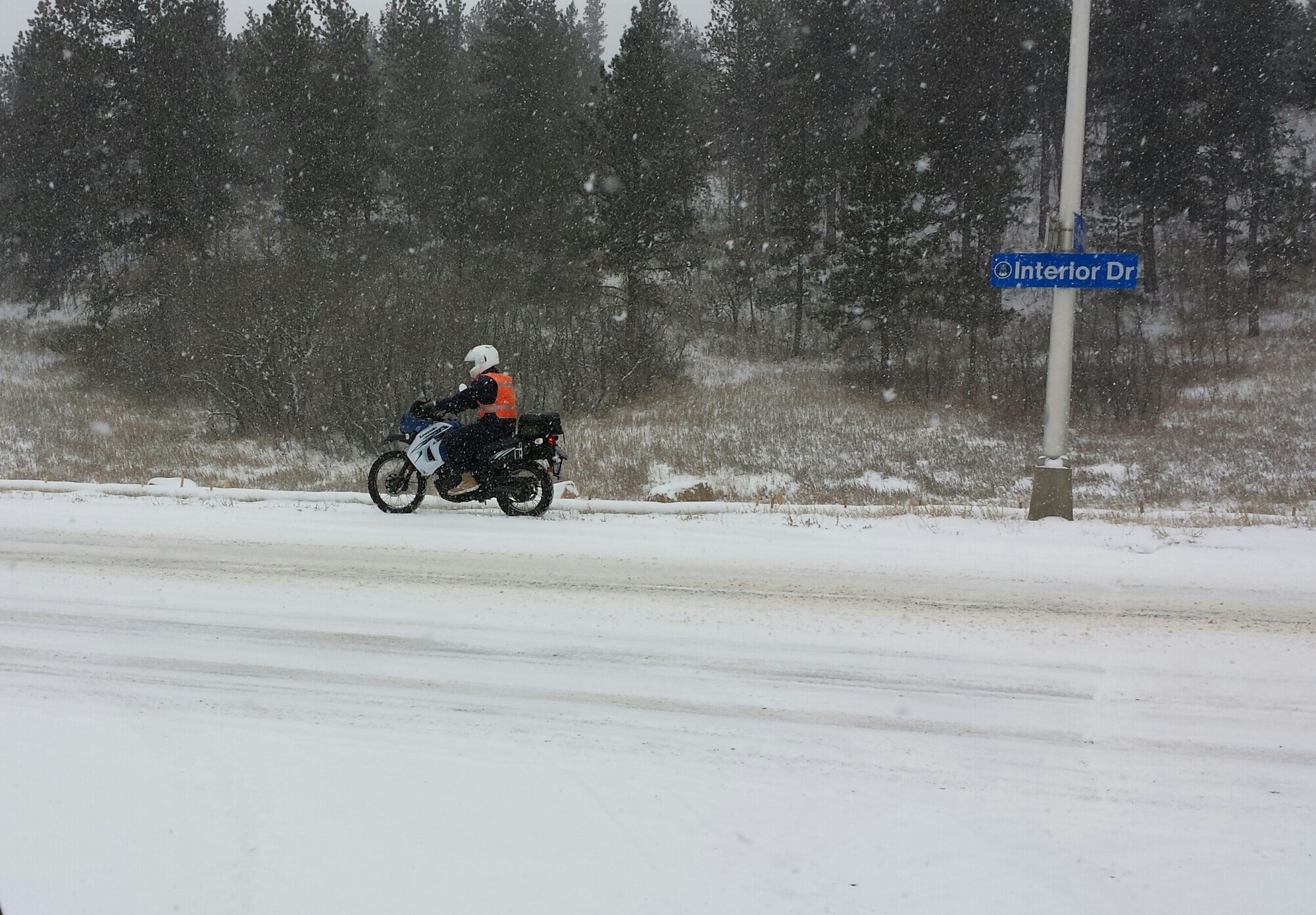 A motorcycle rider braves the snow on Interior Drive here. (U.S. Air Force photo)
