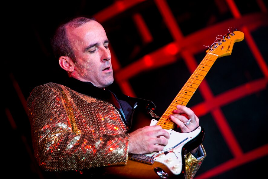 U.S. Air Force Master Sgt. Justin Worley, Tops In Blue first sergeant and lead guitarist, plays a solo Nov. 6, 2014 at the Mathis City Auditorium in Valdosta, Ga. In addition to touring, Tops In Blue performers have non-performance responsibilities such as wardrobe crew or stage set up. (U.S. Air Force photo by Airman 1st Class Ryan Callaghan/Released)
