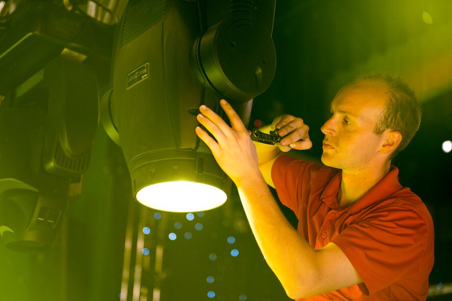 U.S. Air Force Staff Sgt. Blake Whilden, Tops In Blue lighting and technical director, performs preventative maintenance on a lighting fixture Nov. 5, 2014, at the Mathis City Auditorium in Valdosta, Ga. Whilden is in charge of all maintenance and inventory as well as set up and tear-down of the team’s equipment. (U.S. Air Force photo by Airman 1st Class Ryan Callaghan/Released)