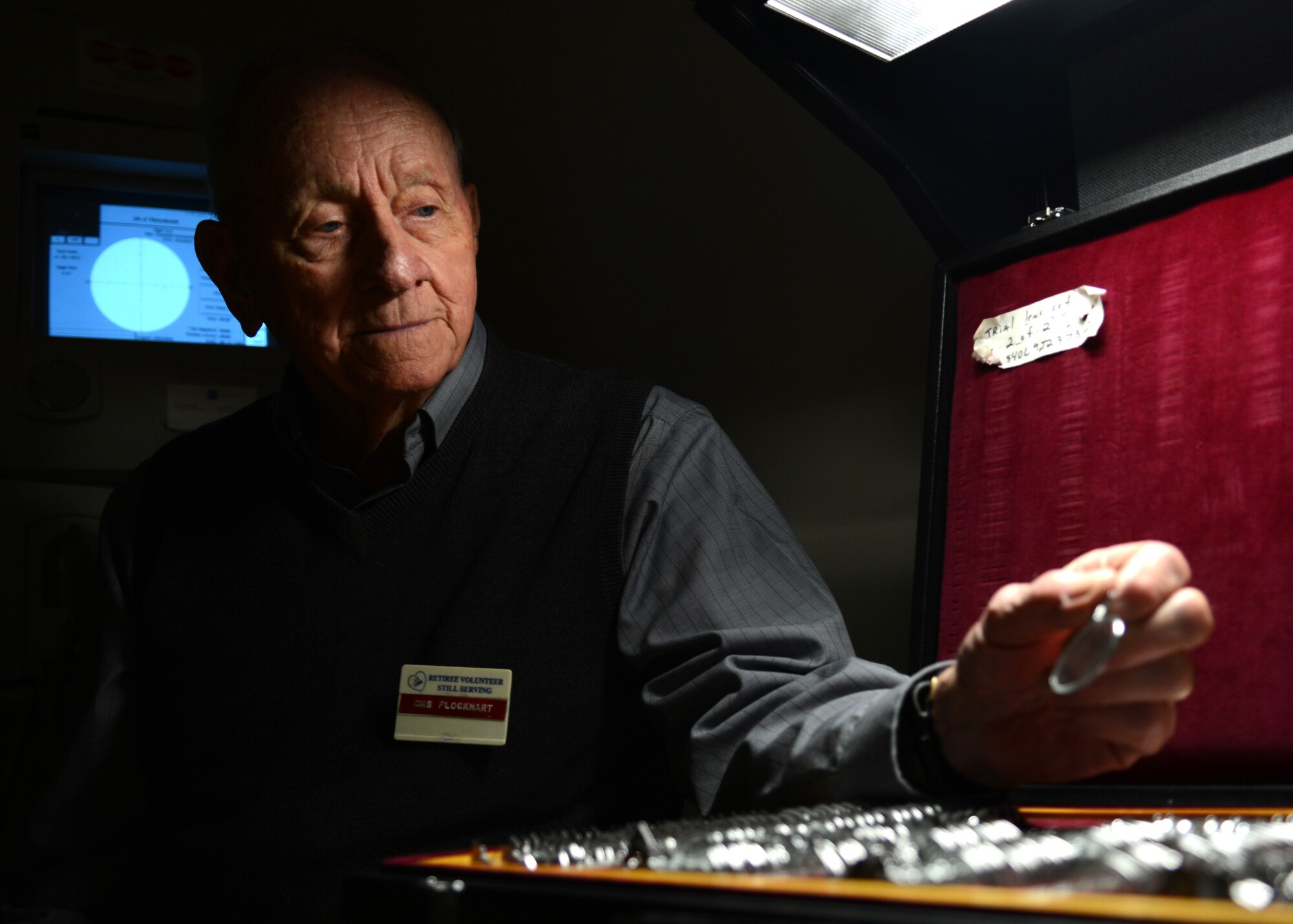 Retired U.S. Air Force Chief Master Sgt. Mark Flockhart selects a lens to insert into a peripheral vision-testing machine at Langley Air Force Base, Va., Nov. 10, 2014. Prior to volunteering at the USAF Hospital Langley optometry clinic, Flockhart volunteered at the dental, dermatology and orthopedics clinics. (U.S. Air Force photo by Airman 1st Class Devin Scott Michaels/Released)