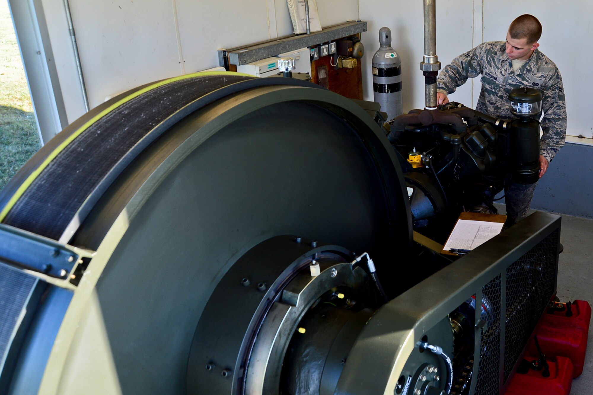 Airman 1st Class Kyle Bradshaw, 48th Civil Engineer Squadron electrical power production journeyman, performs a daily inspection on an aircraft arresting system at Royal Air Force Lakenheath, England, Nov. 4, 2014. Bradshaw was nominated for a Liberty Spotlight because he displays the core value of Excellence in All We Do. (U.S. Air Force photo by Airman 1st Class Erin R. Babis/Released)