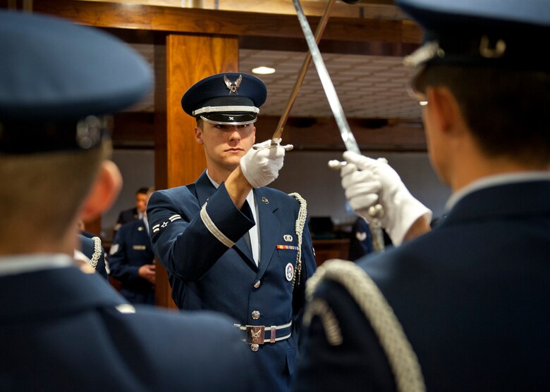 PETERSON AIR FORCE BASE, Colo. – Airman 1st Class Austin Whiting, High Frontier Honor Guard member, holds his sword up for a sword cordon during an event at the Club Nov. 2. The honor guard is an elite team of Airmen here who represent the Air Force by presenting colors, performing retirement ceremonies and providing final tribute for deceased military members as well as other details. (U.S. Air Force photo/Airman 1st Class Rose Gudex)