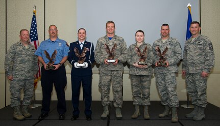 Col. Jeffrey DeVore, 628th Air Base Wing commander (left) and Chief Master Sgt. Mark Bronson, 628th Air Base Wing command chief (right), congratulate (left to right) Glen Pilger, Civilian Category I of the Quarter, Senior Airman Erin Winkler, Honor Guard Member of the Quarter, Capt. Phillip Hoyt, Company Grade Officer of the Quarter, Tech. Sgt. Lyudmila Mueller, NCO of the Quarter, and Master Sgt. Clinton Dunnehoo, Senior NCO of the Quarter during the 628th ABW quarterly awards ceremony Nov. 7, 2014, at the Charleston Club on Joint Base Charleston, S.C. The quarterly awards are held to recognize outstanding Airmen, NCOs, senior NCOs, company grade officers and civilians for their hard work and dedication. (U.S. Air Force photo/Airman 1st Class Clayton Cupit)