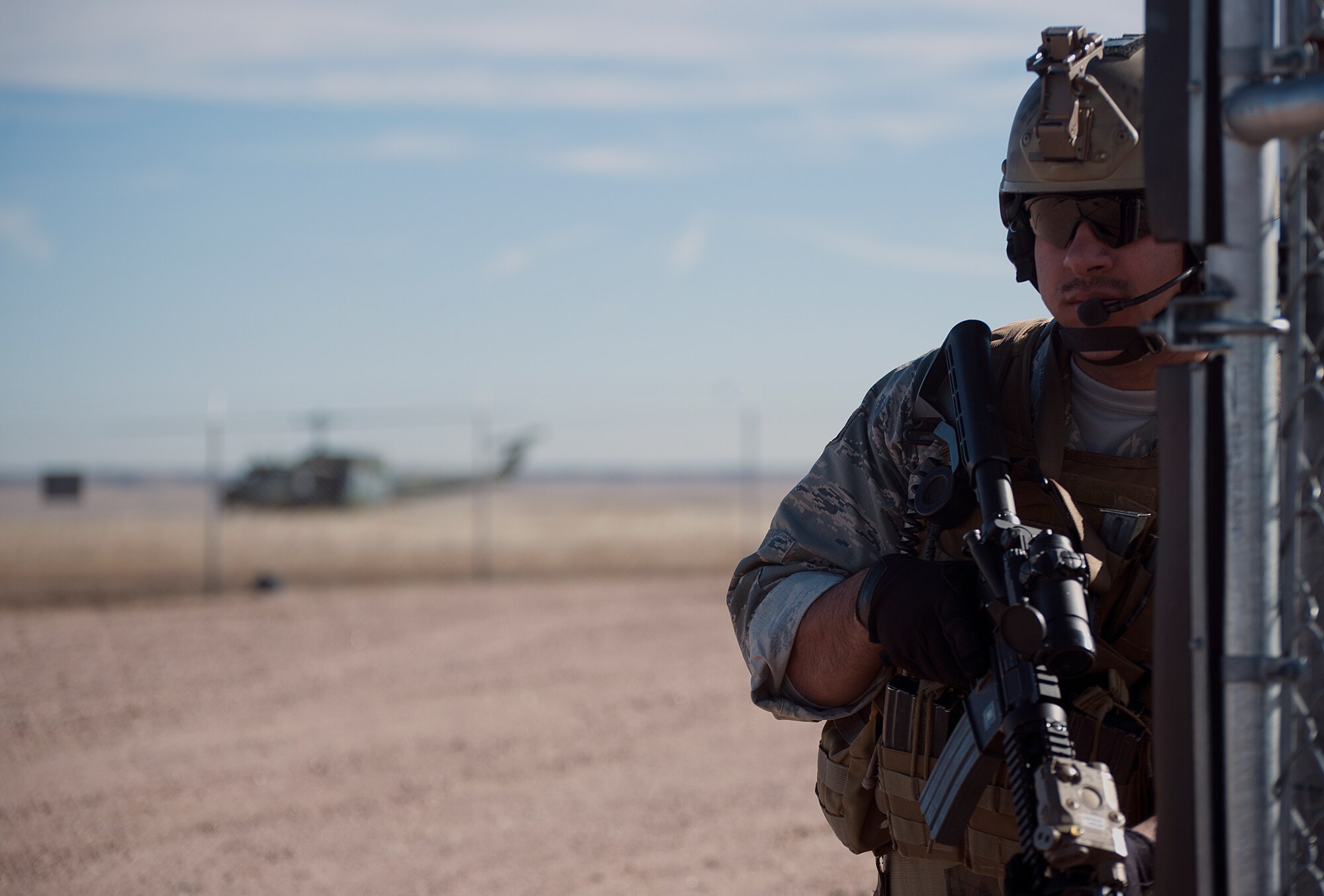 Senior Airman Ronnie Perez, 90th Security Forces Group Tactical Response Force, guards the entrance to the launch facility A-06 Nov. 7, 2014, during a recapture exercise. After recapturing the site, the team sets up to cover the perimeter of the site until it is deemed under control.  (U.S. Air Force photo by Airman 1st Class Brandon Valle)
