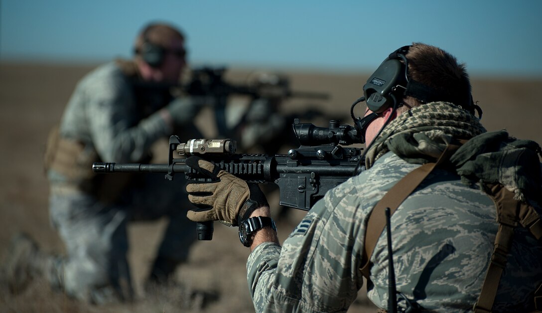 Senior Airman Nicholas Nolan, 90th Security Forces Group Tactical Response Force, provides rear cover as his team prepares to enter the launch facility A-06 during a training exercise Nov. 7, 2014. Security forces Airmen are trained to maintain a 360 degree cover when awaiting orders to move. (U.S. Air Force photo by Airman 1st Class Brandon Valle)
