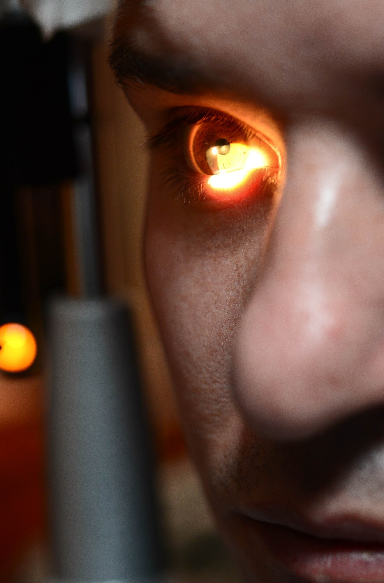 Maj. Charles Malone, 28th Medical Operations Squadron optometrist, performs a slit lamp test on Master Sgt. Mark Slater, 28th MDOS NCO in charge of optometry, at Ellsworth Air Force Base, S.D., Oct. 24, 2014. The test consists of visually evaluating the surface of the eye for anything harmful such as infections or disease. (U.S. Air Force photo by Senior Airman Zachary Hada/Released)