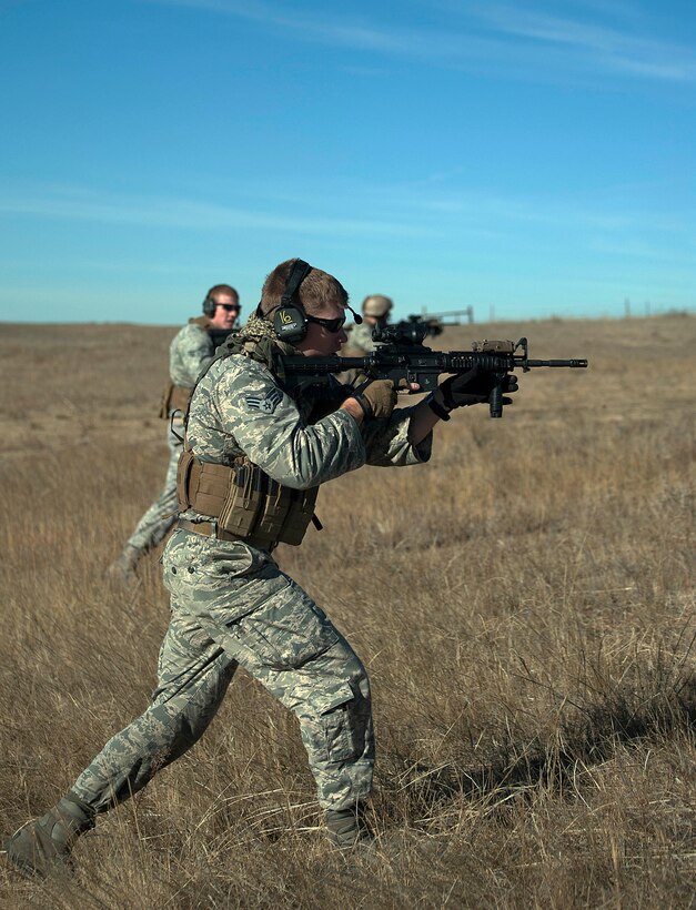 Staff Sgt. Chad Speakman and Senior Airmen Chad Nolan and Bennie Jordan, 90th Security Forces Group Tactical Response Force,  move toward the launch facility A-06 during an LF recapture exercise Nov. 7, 2014. Teams surrounded the LF and made their way to the facility during the exercise.   (U.S. Air Force photo by Airman 1st Class Brandon Valle)

