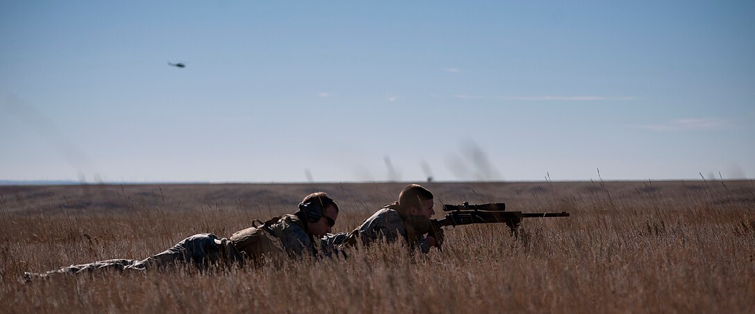 Senior Airman Evan Van Neiuwenhuyze, 90th Security Forces Squadron, provides cover sniper support for other defenders Nov. 7, 2014, during a training exercise to recapture the launch facility A-06. Staff Sgt. Dylan Kempker, 790th Missile Security Forces Squadron, acted as spotter for Van Neiuwenhuyze.  (U.S. Air Force photo by Airman 1st Class Brandon Valle)
