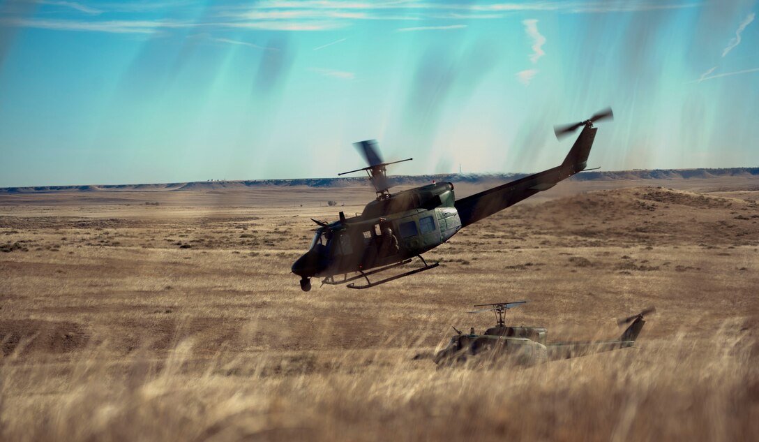 UH-1N helicopters from the 37th Helicopter Squadron take off after dropping off security forces Airman Nov. 7, 2014, outside of the launch facility A-06. The 37th HS works with the 90th Security Forces Group to provide air capabilities for the missile field.  (U.S. Air Force photo by Airman 1st Class Brandon Valle)
