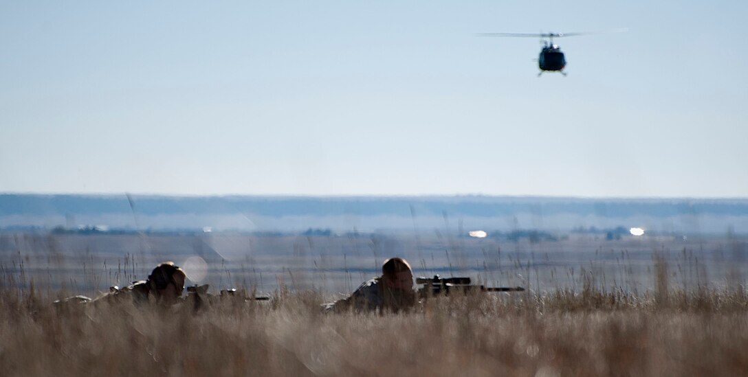 Senior Airman Evan Van Neiuwenhuyze, 90th Security Forces Squadron, provides counter sniper support for security forces Airmen Nov. 7, 2014, during a training exercise to recapture the launch facility A-06. Staff Sgt. Dylan Kempker, 790th Missile Security Forces Squadron, acted as spotter for Van Neiuwenhuyze.  (U.S. Air Force photo by Airman 1st Class Brandon Valle)
