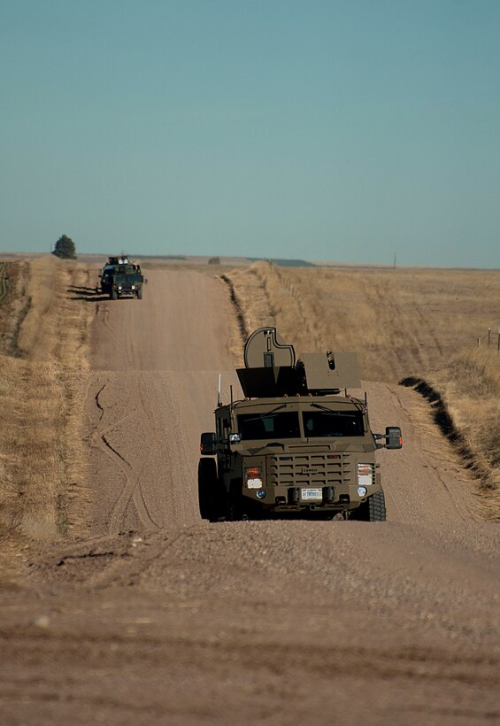 A BearCat filled with security forces Airmen travels down a gravel road towards launch Facility A-06  Nov. 7, 2014, during a LF recapture training exercise. Security forces Airmen use the Bearcats to protect them as they patrol missile sites. (U.S. Air Force photo by Airman 1st Class Brandon Valle)  
