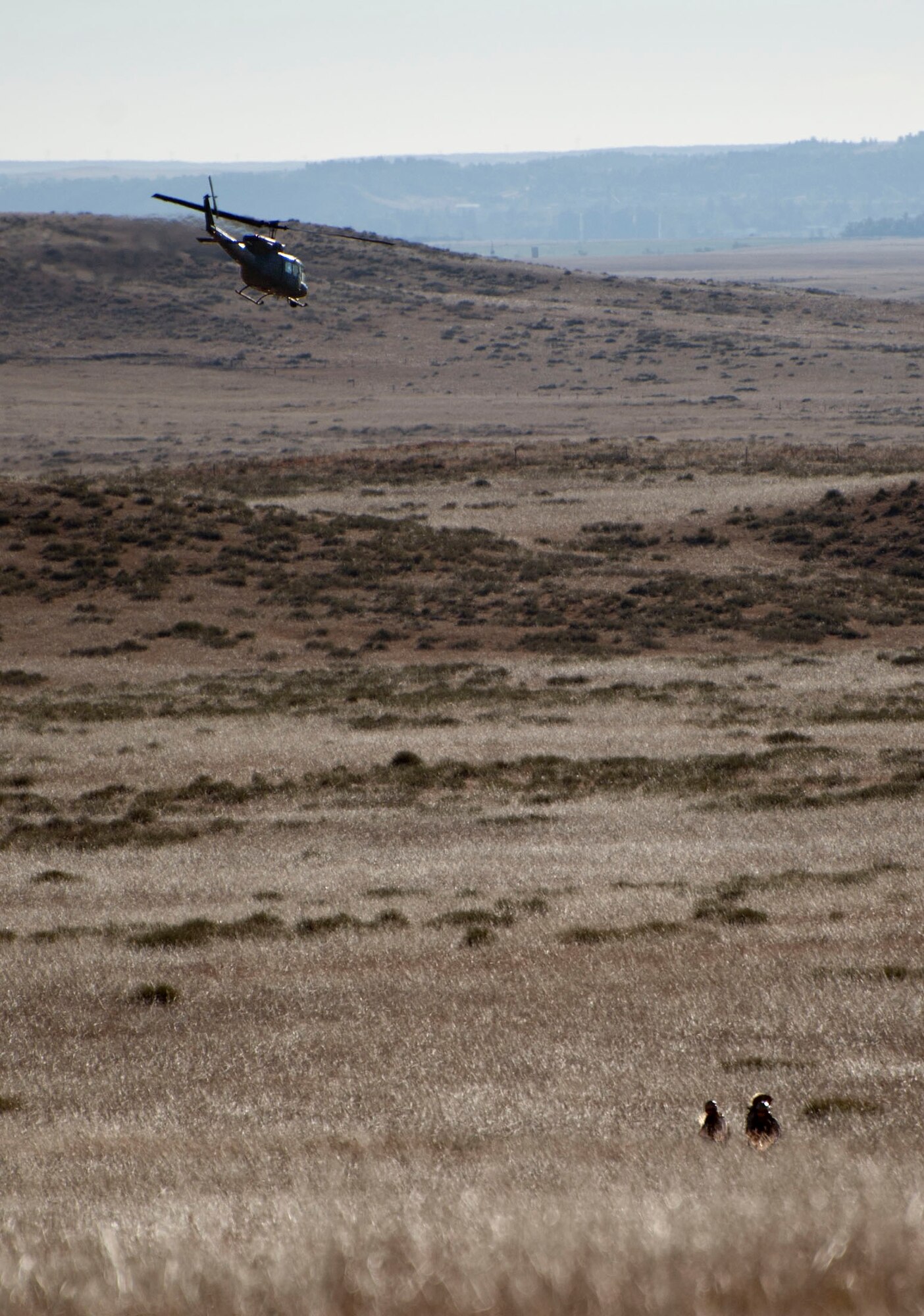 A UH-1N helicopter from the 37th Helicopter Squadron after tactically inserting Airmen from the 90th Security Forces Group Tactical Response Force Nov. 7, 2014, during a training exercise at launch facility A-06. The 37th HS works with the 90th SFG to provide air capabilities for the missile field. (U.S. Air Force photo by Airman 1st Class Brandon Valle)

