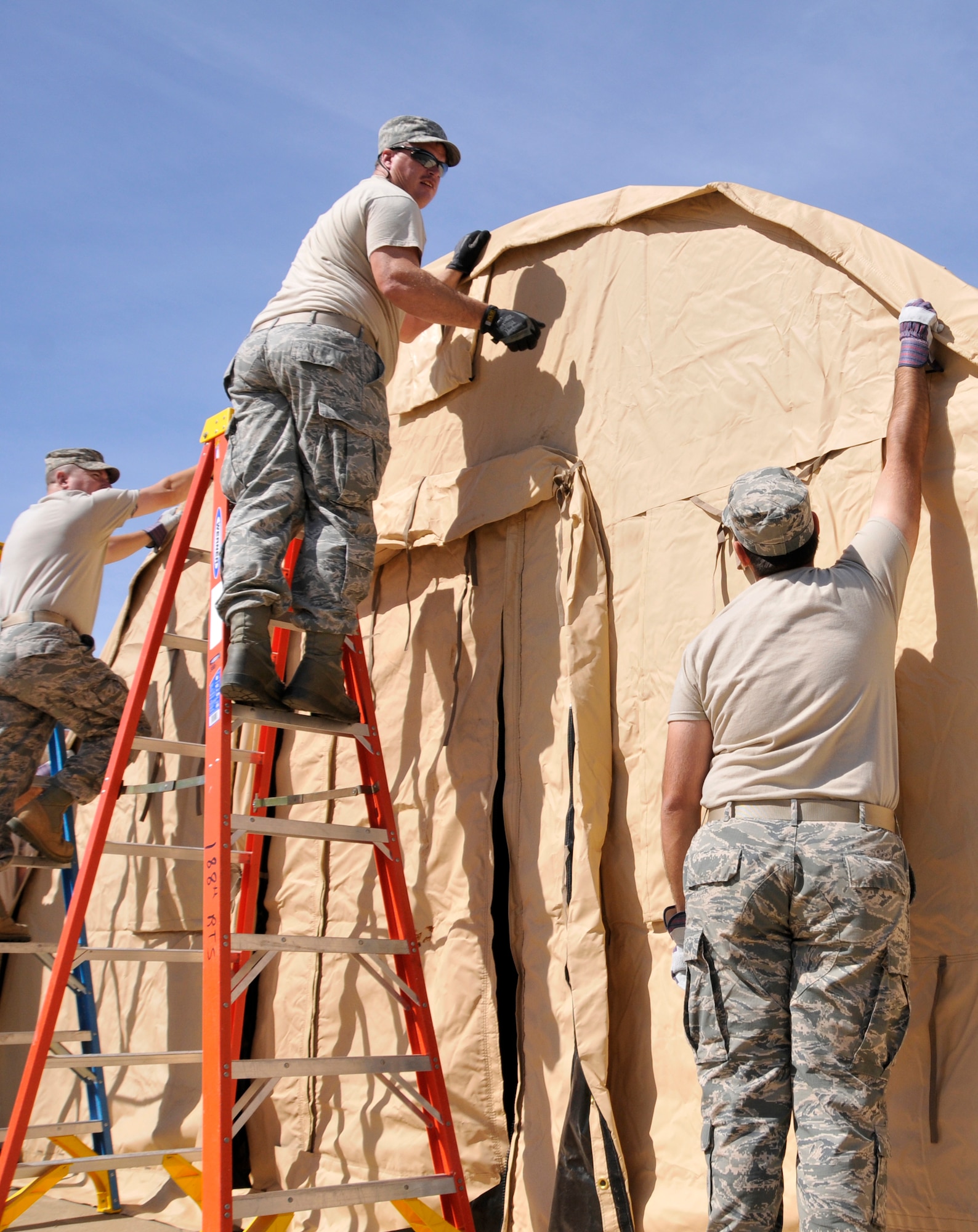 Members of the 188th Civil Engineering Squadron work to erect a tent during a bivouac training exercise at Ebbing Air National Guard Base, Fort Smith, Ark., Oct. 4, 2014. (U.S. Air National Guard photo by Staff Sgt. John Suleski/released) 