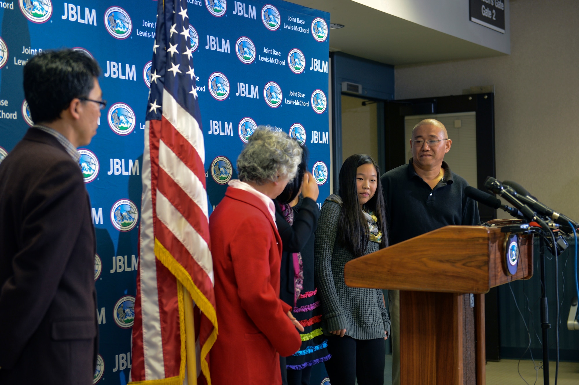 Kenneth Bae (right), one of the last two American citizens imprisoned in North Korea, alongside his family, greets members of the media during a press conference Nov. 8th, 2014, at Joint Base Lewis-McChord, Wash. Bae was reunited with his family after spending more than two years in a North Korean prison. (U.S. Air Force photo/Staff Sgt. Russ Jackson)