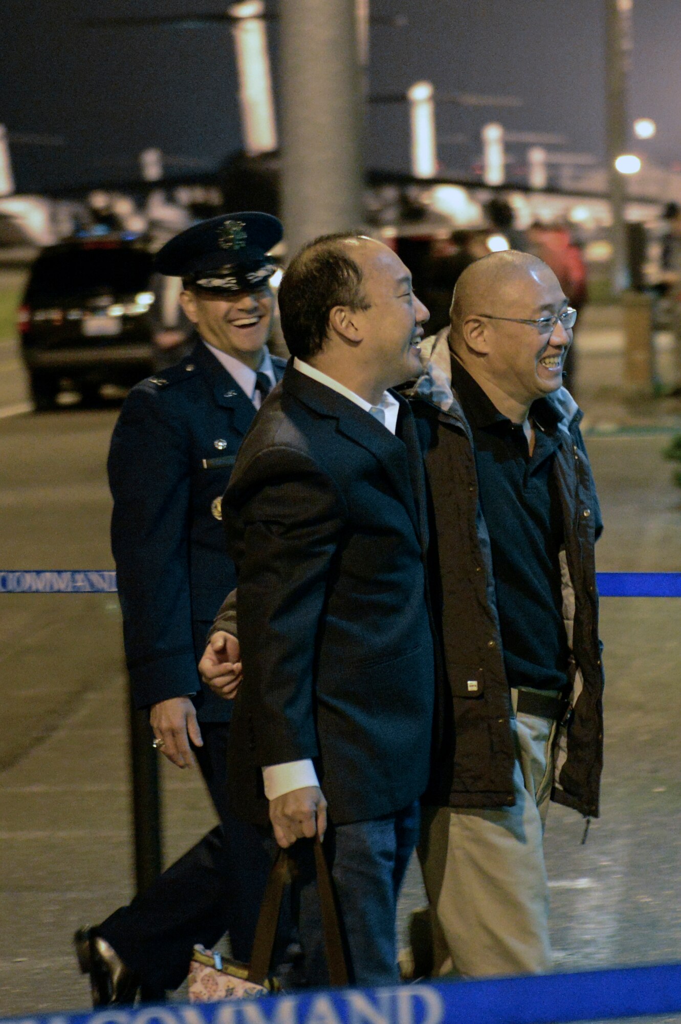 Kenneth Bae (right), one of the last two American citizens imprisoned in North Korea, is escorted by Col David Kumashiro (left), 62nd Airlift Wing commander, into the McChord Field Passenger Terminal Nov. 8th, 2014, at Joint Base Lewis-McChord, Wash., after spending more than two years in a North Korean prison. In November of 2012, Bae led a group of tourists into North Korea where he was arrested and accused of trying to overthrow the government and was sentenced to 15 years of hard labor. (U.S. Air Force photo/Staff Sgt. Russ Jackson)