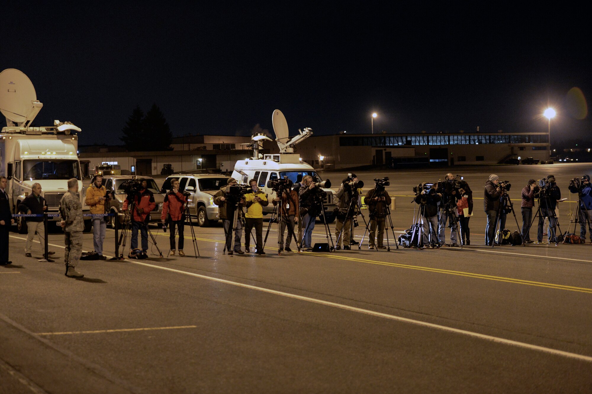 Camera crews and reporters from numerous new agencies await the arrival of Kenneth Bae and Matthew Miller, the last two American citizens imprisoned in North Korea Nov. 8th, 2014, at Joint Base Lewis-McChord, Wash. Bae and Miller were released by North Korean leader, Kim Jong Un and brought to JBLM to be re-united with their families. (U.S. Air Force photo/Staff Sgt. Russ Jackson)