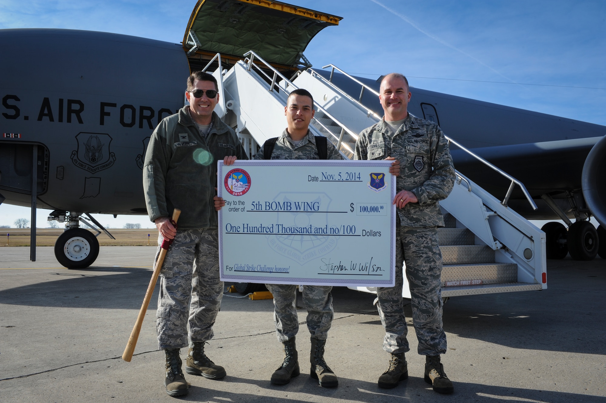 (from left to right) Col. Tom Rudy, 91st Missile Wing vice commander, Senior Airman William Atkins, 705th Munitions Squadron Global Strike Challenge team member and Col. Jeffrey Neischel, 5th Bomb Wing vice commander, hold a check for $100,000 on Minot Air Force Base, N.D., Nov. 6, 2014. The money will be used for quality of life improvements on the base. (U.S. Air Force photo/Senior Airman Stephanie Morris)