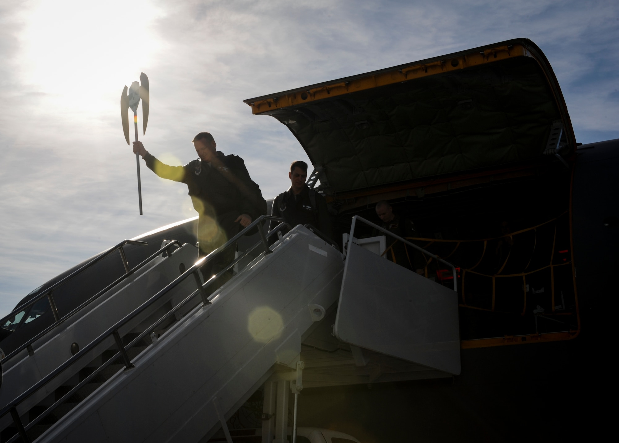 Col. Kieran Denehan, 5th Operations Group commander, carries a scepter topped by the 5th Bomb Wing logo is hoisted above a 5th BW team member’s head as they return from the Air Force Global Strike Challenge  on Minot Air Force Base, N.D., Nov. 6, 2014. The teams received their scores the previous day at Barksdale Air Force Base, La. (U.S. Air Force photo/Senior Airman Stephanie Morris)